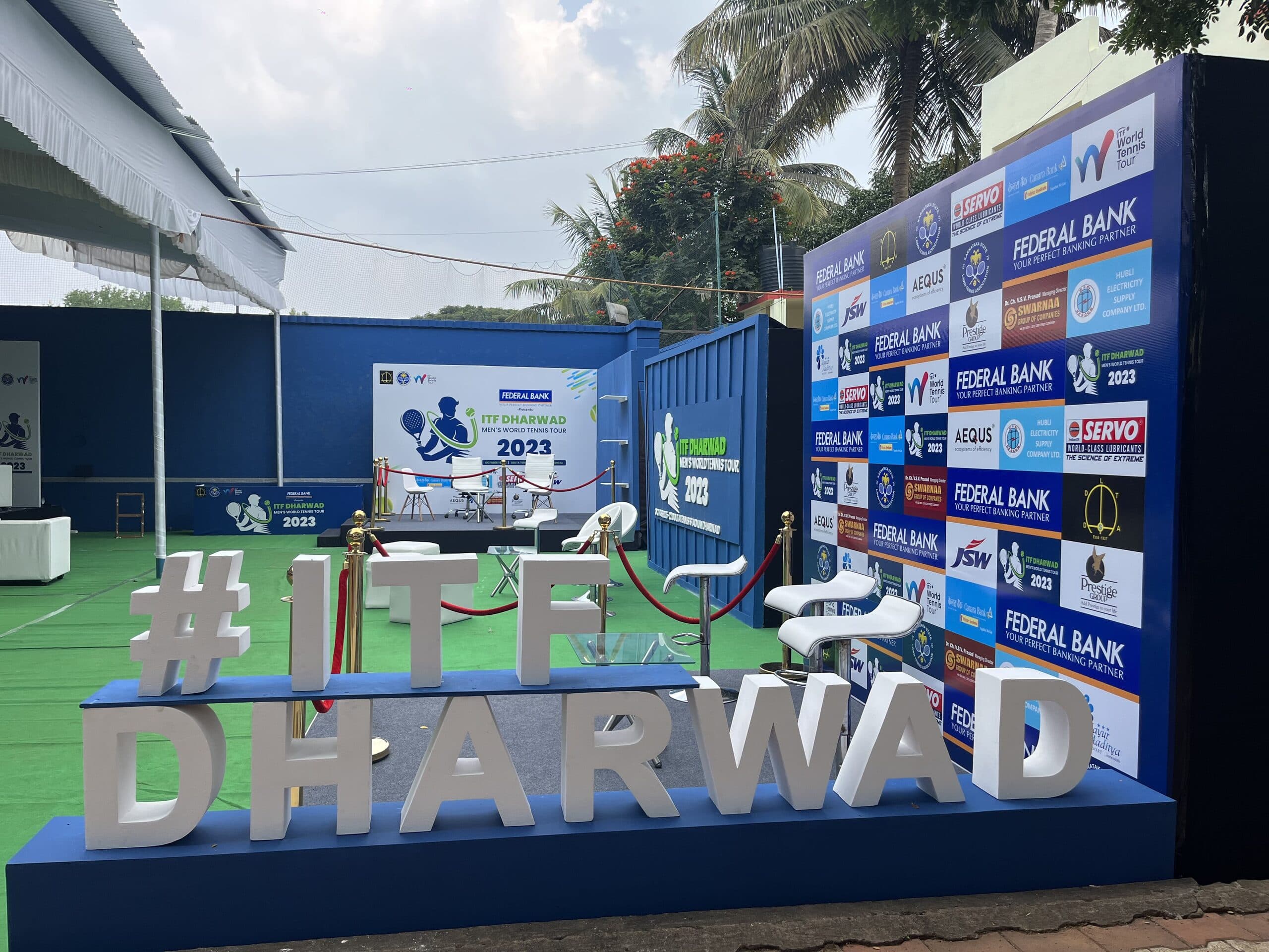 ITF Dharwad venue installation with tournament branding and sponsor wall