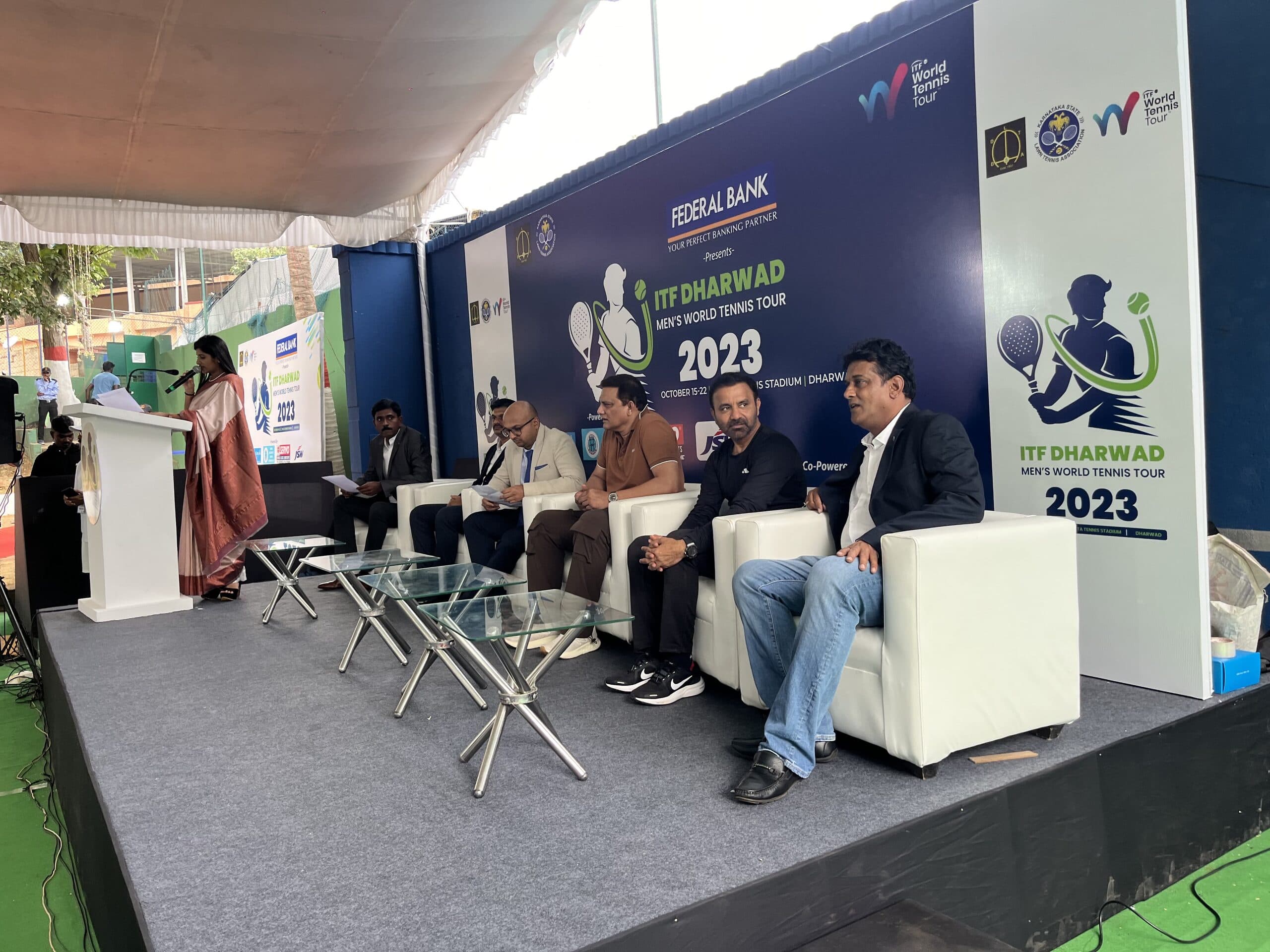 Wide view of a speaker addressing the seated ITF Dharwad event panel