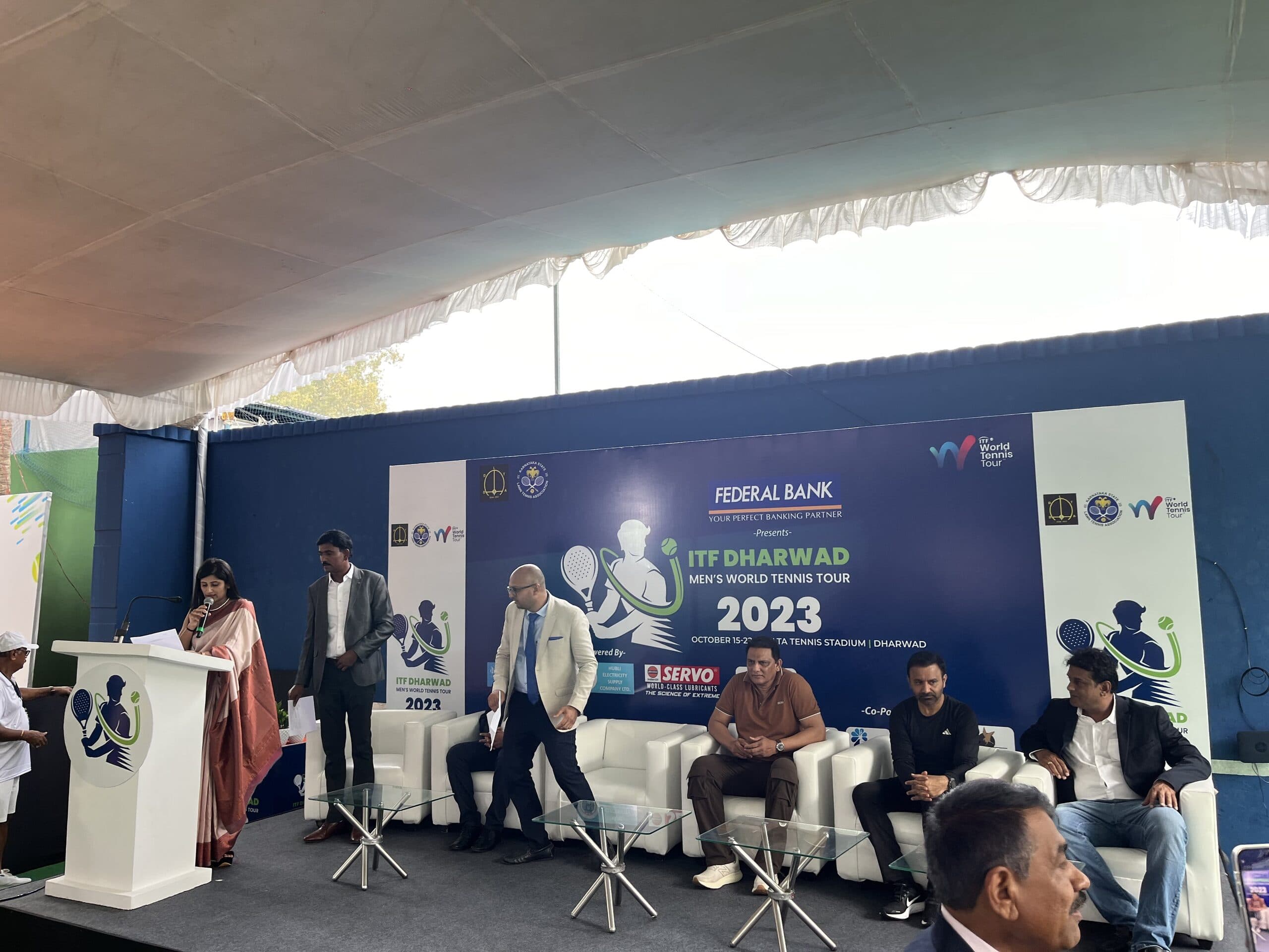 ITF Dharwad presentation stage with tournament guests and branding