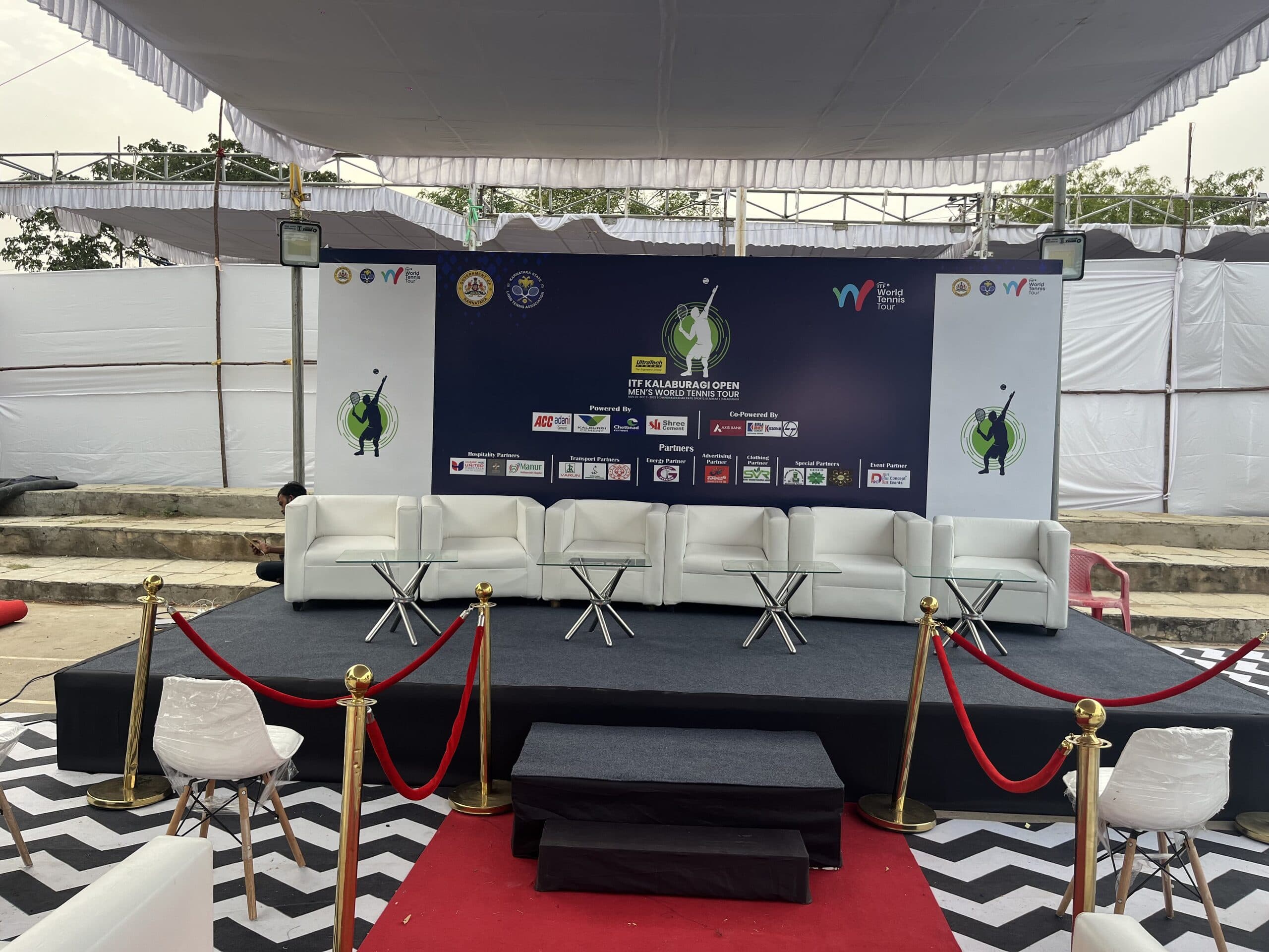 Front view of the branded ITF Kalaburagi Open panel stage