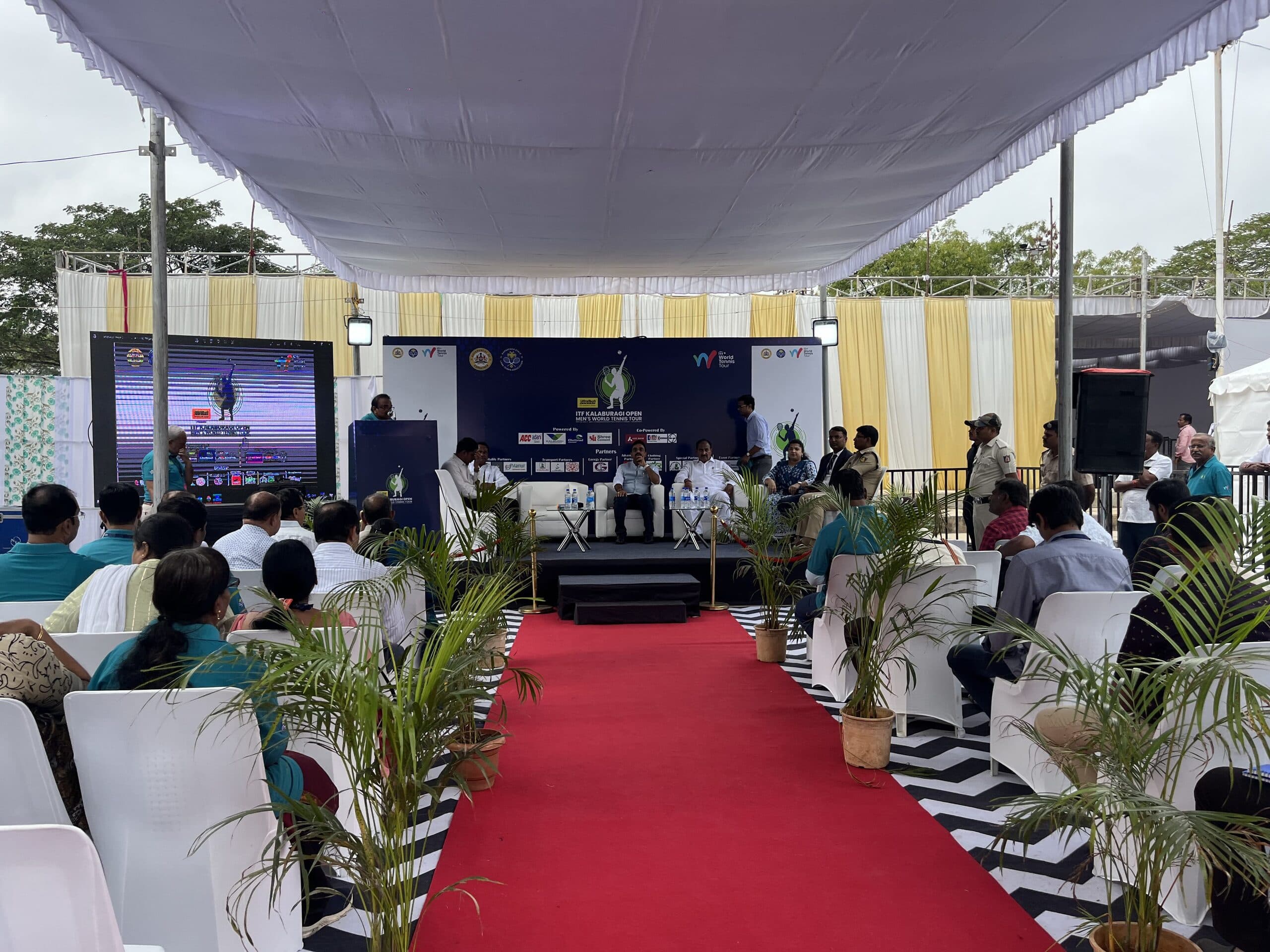 Audience facing the ITF Kalaburagi Open presentation stage