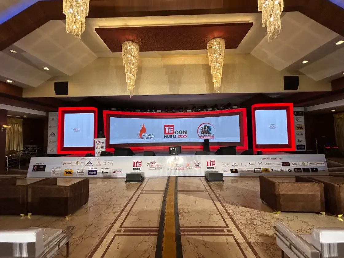 TiE conference panel on an LED stage