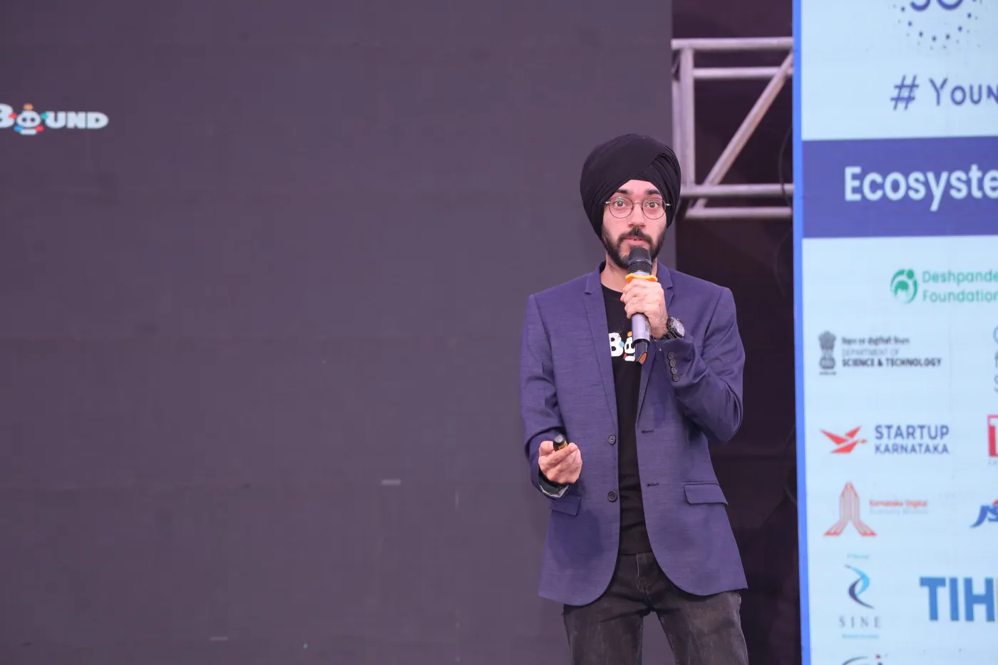 Speaker addressing a startup summit from the stage