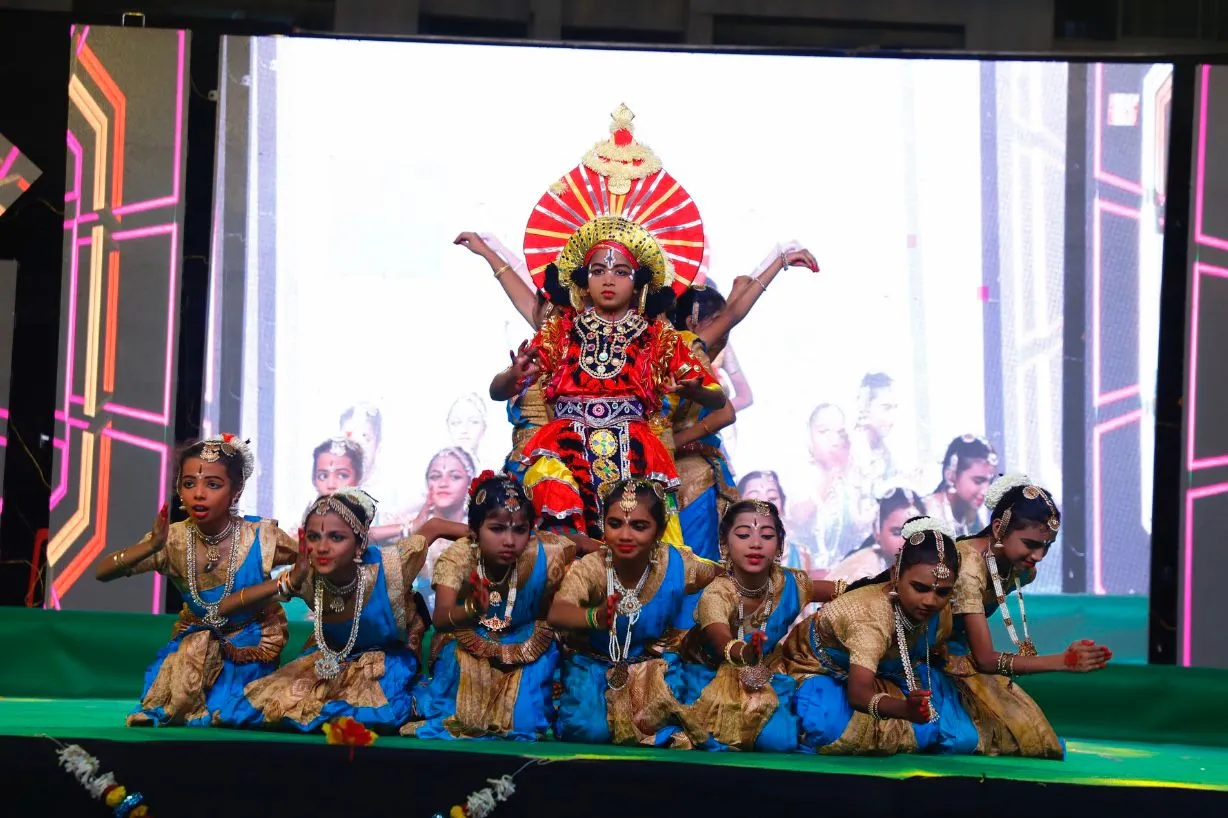 Folk dancers in traditional costume on a festival stage