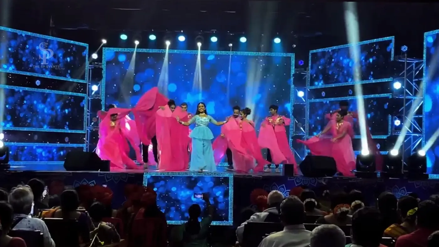 Dancers in pink on an LED festival stage