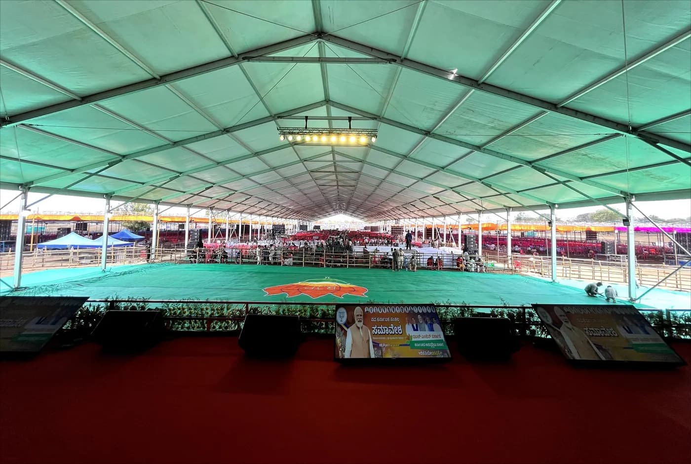 Civic ceremony under a vast tent seen from above