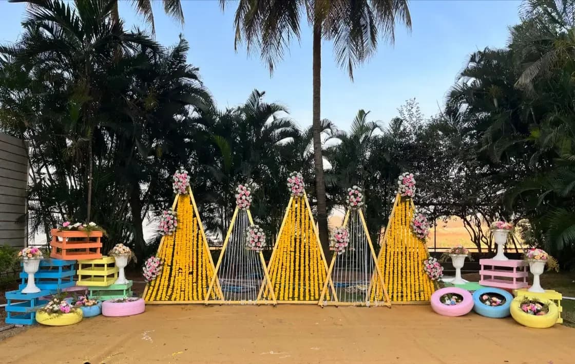Haldi setup with marigold cones and palm fronds