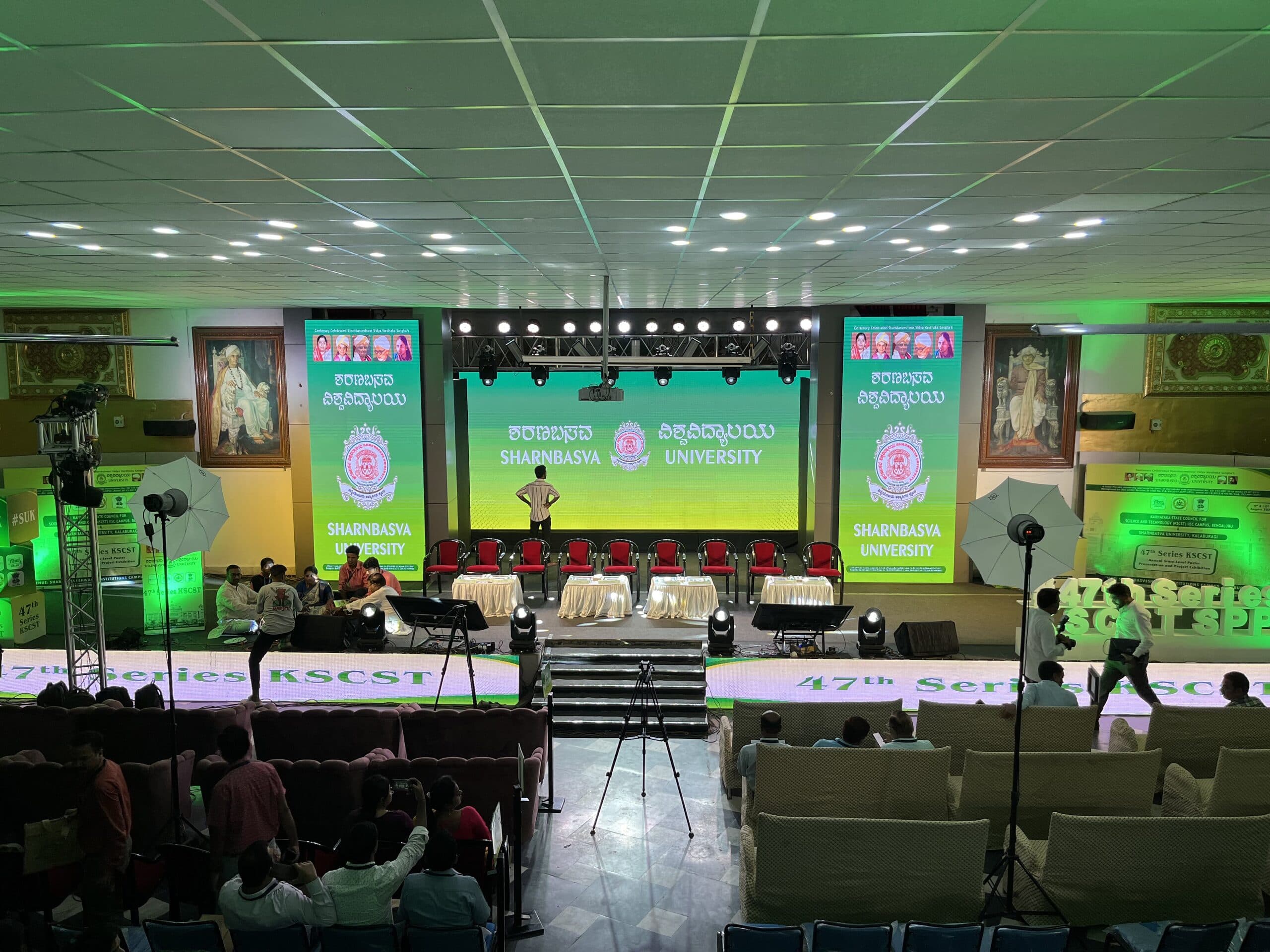 Front-on view of the stage, its jury seating and draped tables before the session